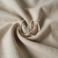Silver-coloured spiral earrings with flat profile