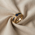 Gold-Coloured Ring with Blue Centre Stone and Rows of Crystals