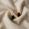 Aurora gold-coloured earrings with black stone