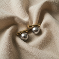 Elegant dark pearl earrings with gold