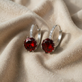Silver earrings with ruby and zircon