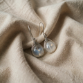 Silver moonstone drop earrings featuring polished silver settings