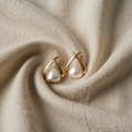 Vintage-inspired cross-shaped triangular pearl earrings with clear pearls