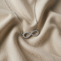 Necklace with white gold pendant and infinity symbol zircon
