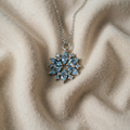 Blue Snowflake Pendant on a White Gold Necklace with Floral Motif